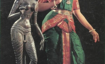 An image of a Sculpture and a girl with Bharatanatyam pose.