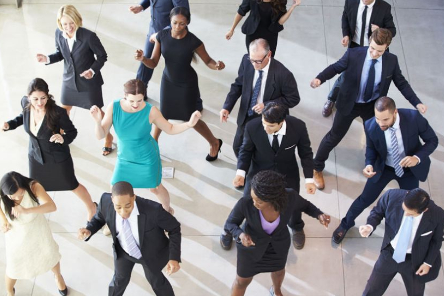 Employees dancing and being stress-free at work.